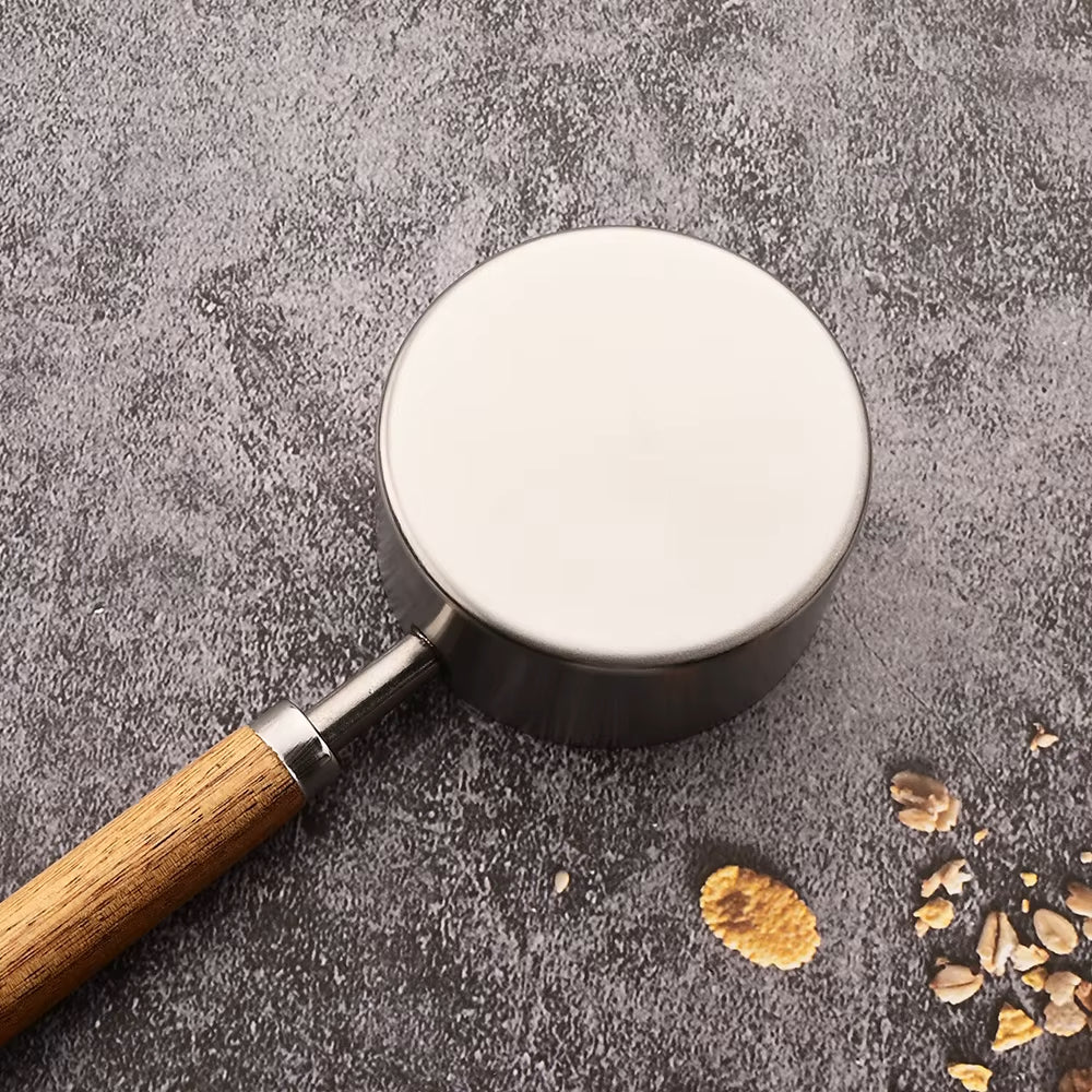 Close Up Silver Stainless Steel Metal Measuring Cup With Wood Handle